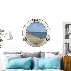 Autocollant mural fausse fenêtre ronde en trompe-l'oeil comme un hublot de bateau avec vue sur la dune du pilat et eau turquoise mis en ambiance comme tête de lit