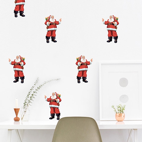 Sticker Planche Père Noël Sticker Père Noël collé sur un mur blanc au-dessus d'une table