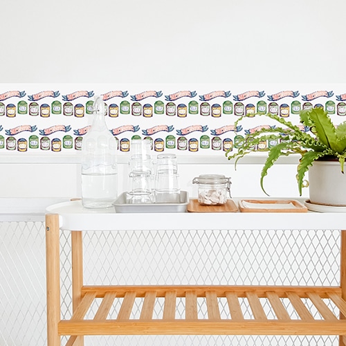 cuisine d'un appartement moderne sous les toits avec sticker motif fleurs exotiques roses collé sur la porte ce qui vient compléter le style tendance et le côté cosy de cet intérieur