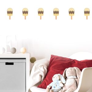 ligne de stickers pour enfant vanille chocolat mis en ambiance sur un mur blanc