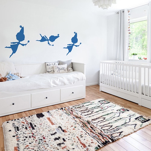 trois stickers muraux fées bleues mis en ambiance sur un mur blanc d'une chambre de bébé