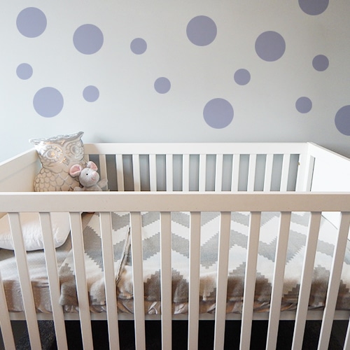 Adhésif rond violet pâle pour déco de mur au dessus d'un berceau d'enfant