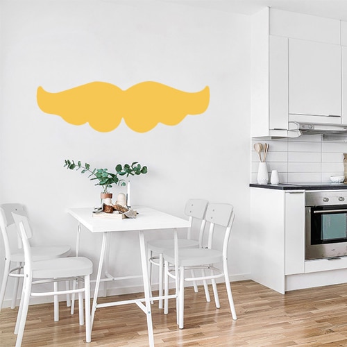 sticker moustache jaune autocollant posé au mur d'une cuisine