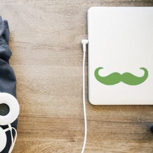 PC portable fermé avec un sticker autocollant moustache en croc verte