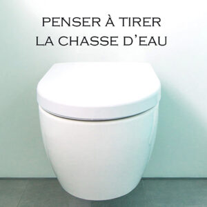 Toilettes blancs avec un sticker adhésif instruction Penser à tirer la chasse d'eau au mur