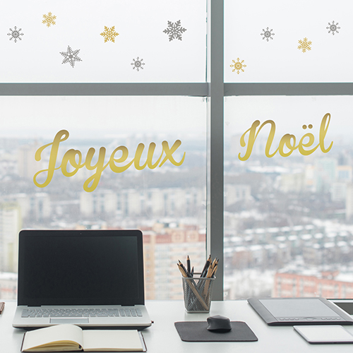 Stickers déco électrostatiques joyeux noel collé sur la fenetre d'un grand bureau pour les fêtes de fin d'année