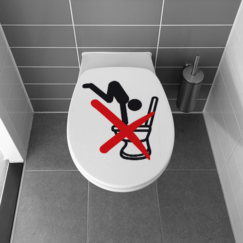 Toilettes blanches décorées avec un sticker WC interdit de plonger