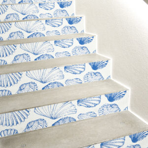 Stickers décoratifs coquilles St Jacques bleues sur fond blanc collés sur des escaliers en béton blanc