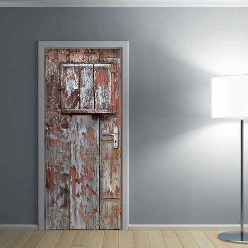 Porte adhésive sticker trompe l'oeil d'une porte de grange en bois délavé avec peinture écaillée