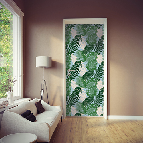 studio avec sticker décoratif fougère salle de séjour collé sur la porte avec palme mint et vert foncé menthe