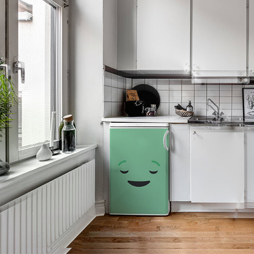 Petit frigo moderne orné d'un sticker décoratif Smiley Endormi vert